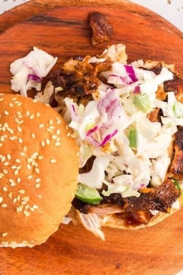 Pulled pork made in an air fryer on a sesame seed bun topped with coleslaw.