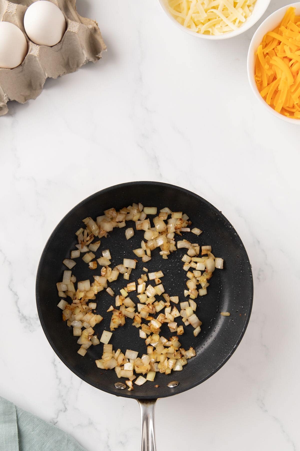 Cooking chopped onions in a skillet. 