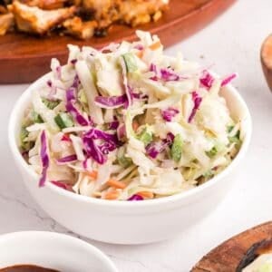 A bowl of spicy coleslaw with red and green cabbage.