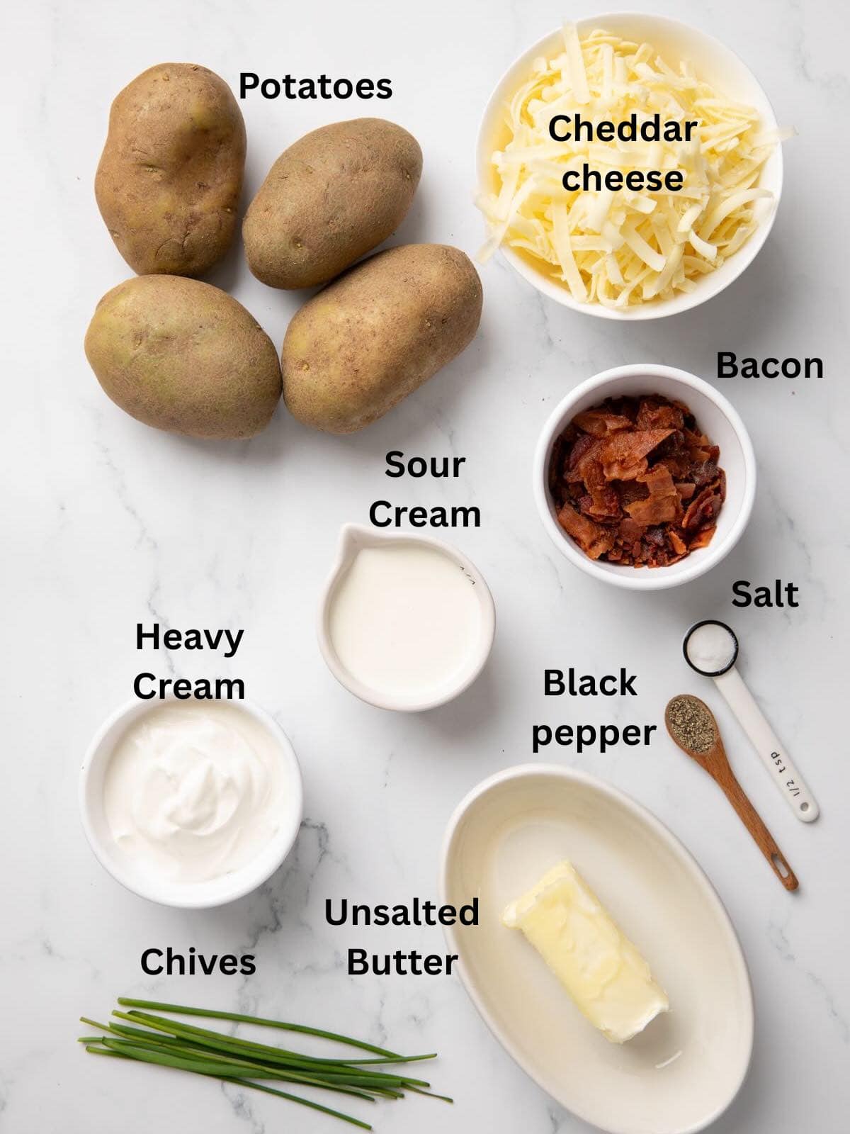 Ingredients for twice-baked potatoes include potatoes, shredded cheese, heavy cream, and sour cream. 