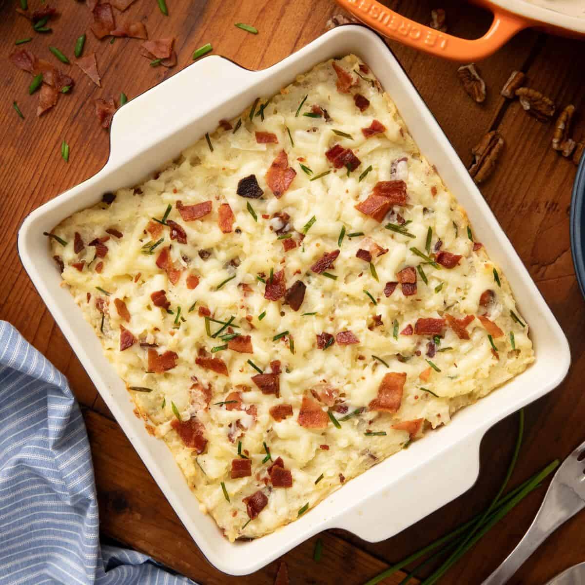 Twice Baked Mashed Potatoes in a square casserole dish right out of the oven and ready to serve.
