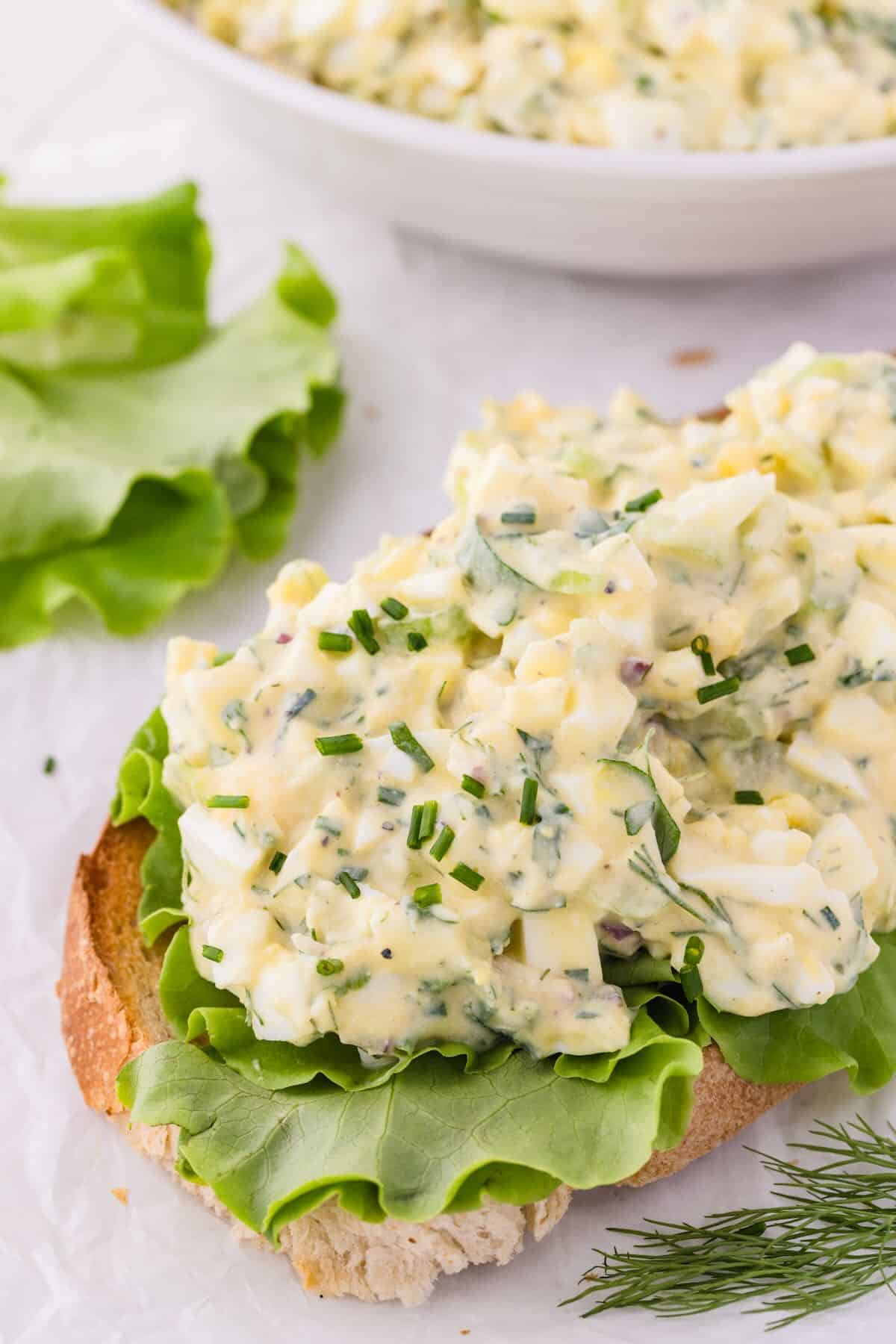Egg salad made with cottage cheese on a piece of bread and with lettuce. 