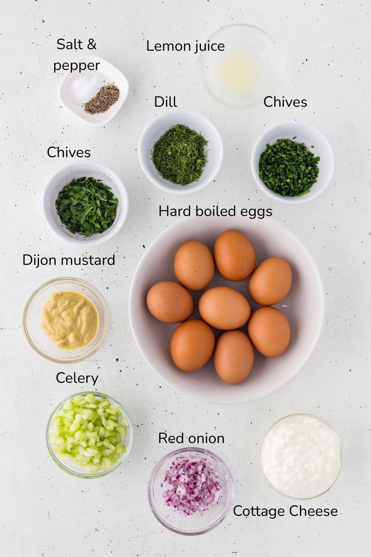 Ingredients for egg salad with cottage cheese include hard boiled eggs, cottace cheese, celery, mustard, and various herbs.