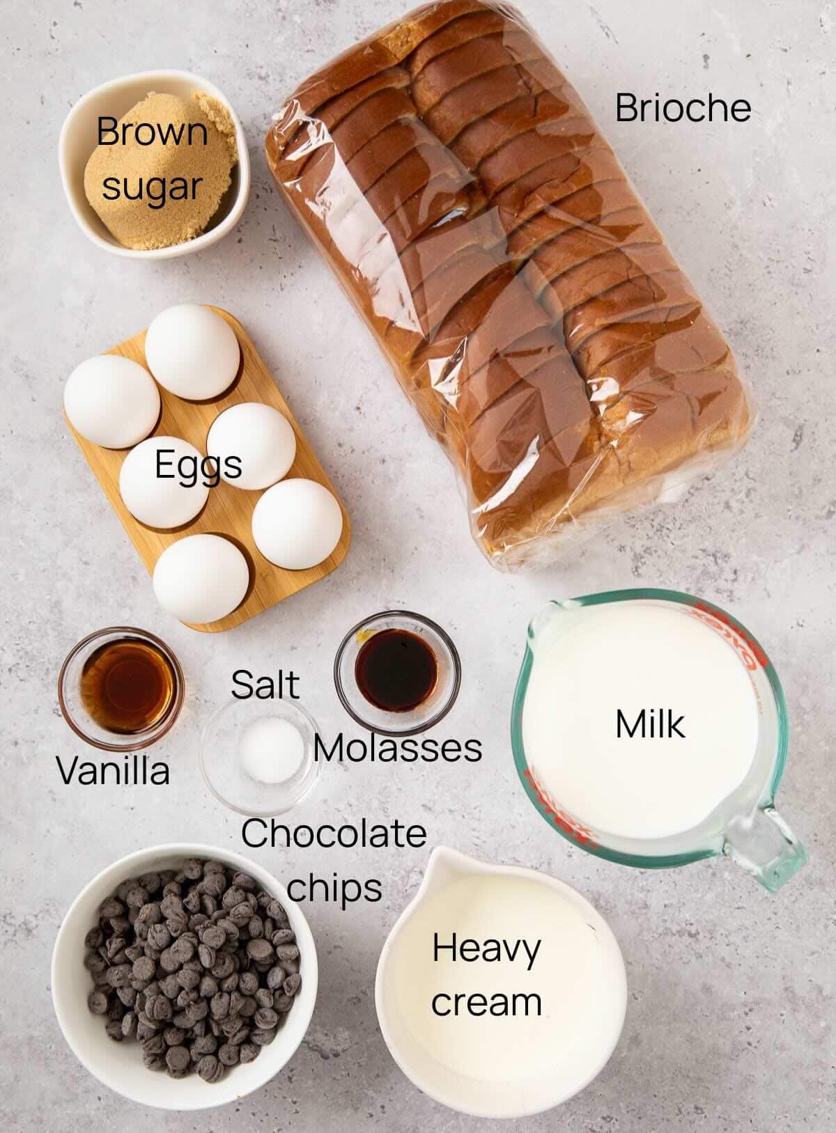 Ingredients for baked french toast with brioche bread and chocolate chips include eggs, milk, bread, heavy cream and sugar.