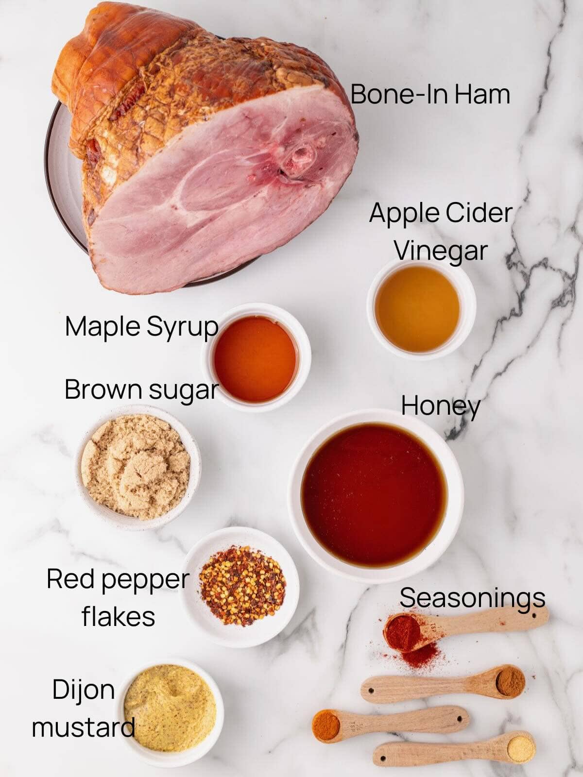 Ingredients for spicy maple glazed ham include a whole bone-in-ham, maple syrup, honey, brown sugar and red pepper flakes.