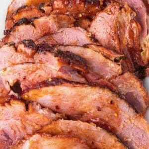 Slices of spicy maple glazed ham on a platter.