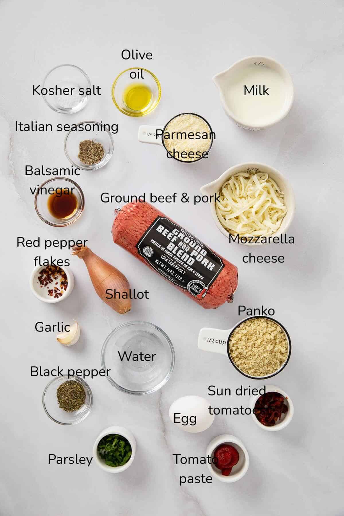 Ingredients for meatloaf include ground beef and pork, panko crumbs, milk, mozzarella and parmesan cheeses, tomato paste, and seasonings.